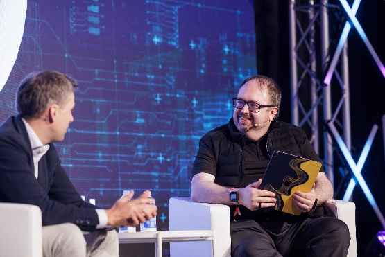 Panel discussion on stage with a conference audience